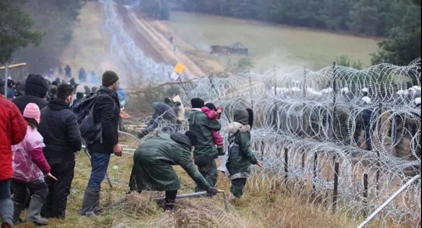 难民在波兰边界被铁丝网拦住 图源:路透社