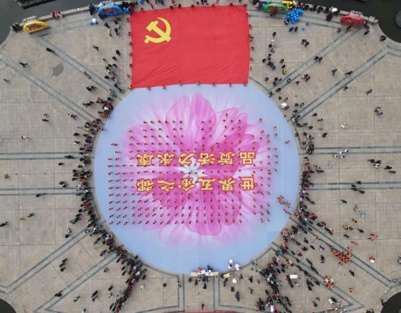 在逐渐激昂的鼓点声中,30位女护旗手托举着长20米,宽13米的巨大的党旗