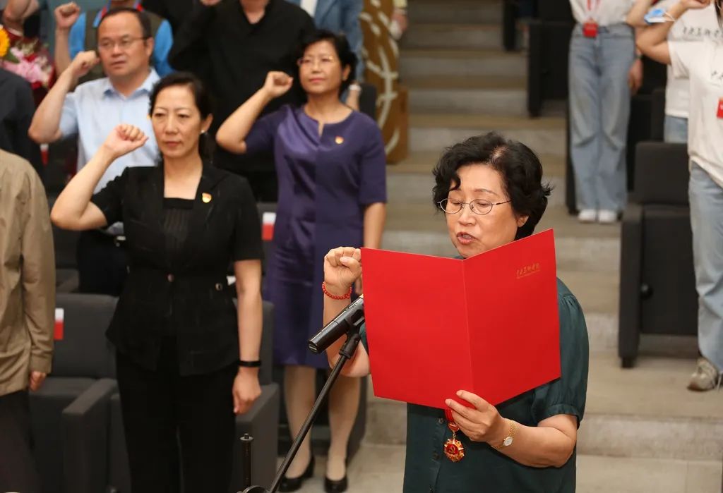 纪念章获得者代表,原党委副书记黄华英领誓重温入党誓词,现场气氛庄重