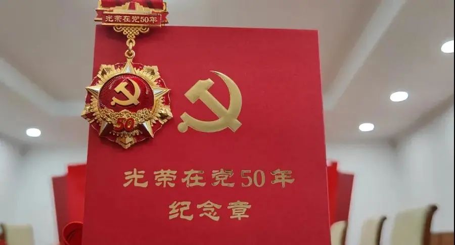 党组书记,院长陈勇为老干部代表佩戴"光荣在党50年"纪念章面向党旗