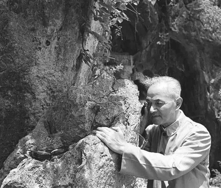 1957年6月，李四光在杭州飞来峰用放大镜察看石灰岩中的有孔虫化石