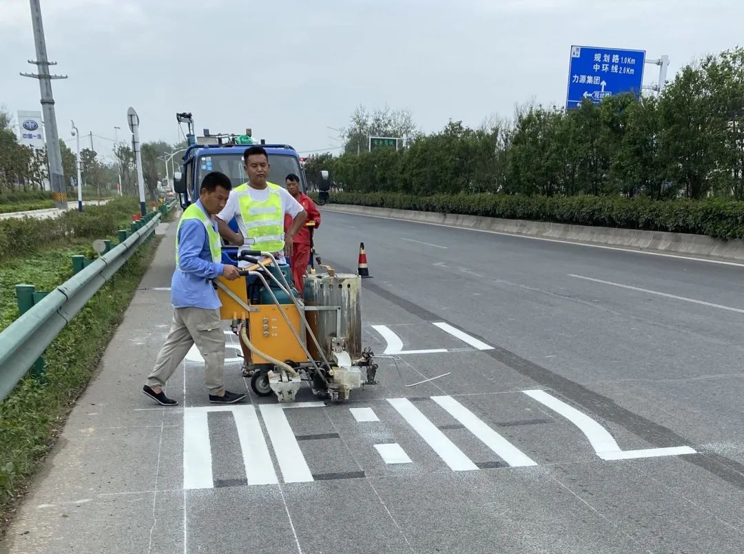 8月12日,淮上大道中環線路段,施工人員正在緊張忙碌中,使用道路劃線機