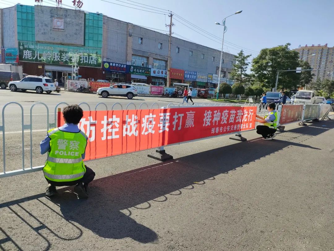 疫情防控珲春公安交警悬挂防疫宣传条幅提高群众安全防控意识