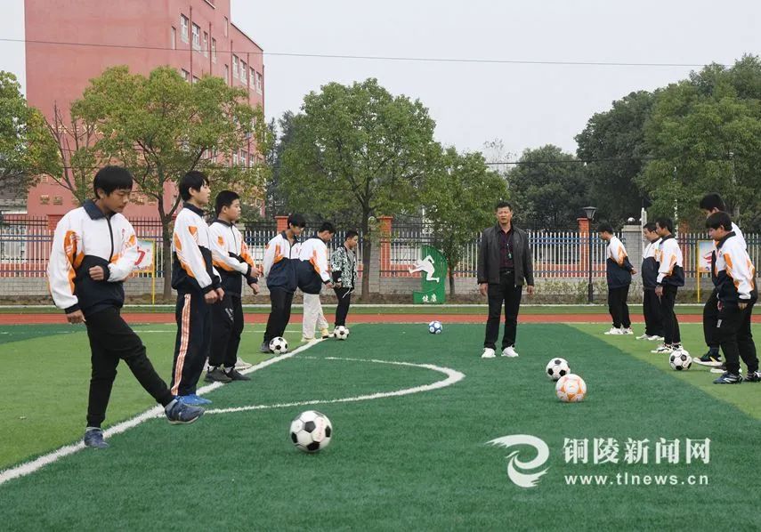 日前,郊区红阳初级中学的操场上,学生们在练习足球.