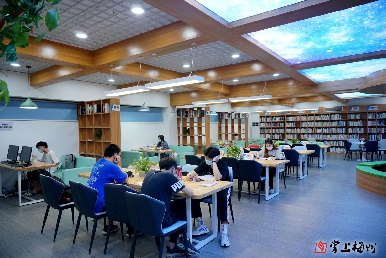 在市剑英图书馆智慧书房,读者们均佩戴口罩学习"充电",静静地品味书香