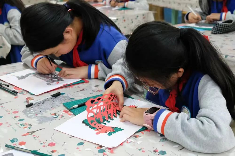 志愿者向学生们详细介绍温州细纹刻纸技艺的发展历史及制作工艺,并