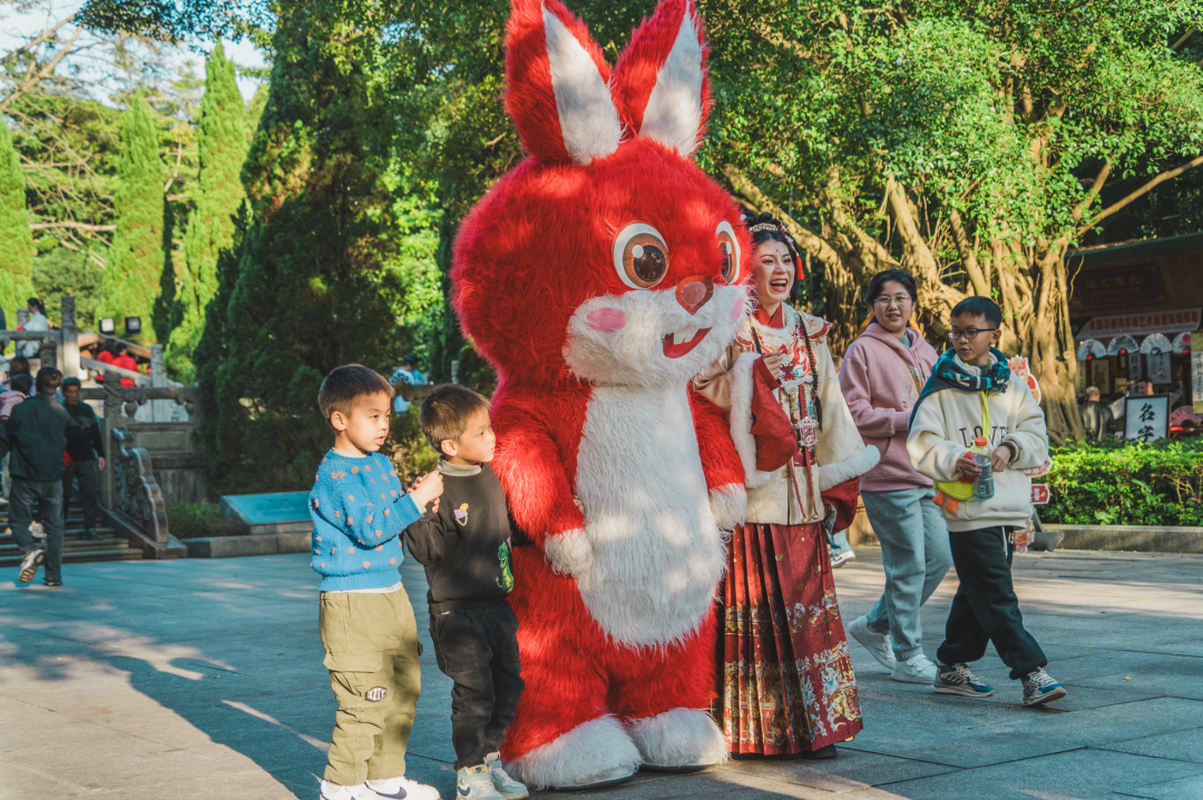 纷纷与人偶互动,拍照,萌兔,龙年人偶吸引了不少游客的眼球,景区内不