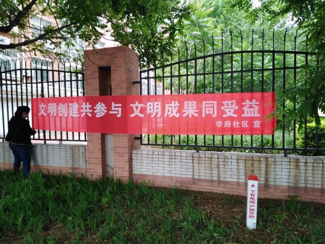 活动中向居民发放宣传单,并悬挂创城宣传条幅