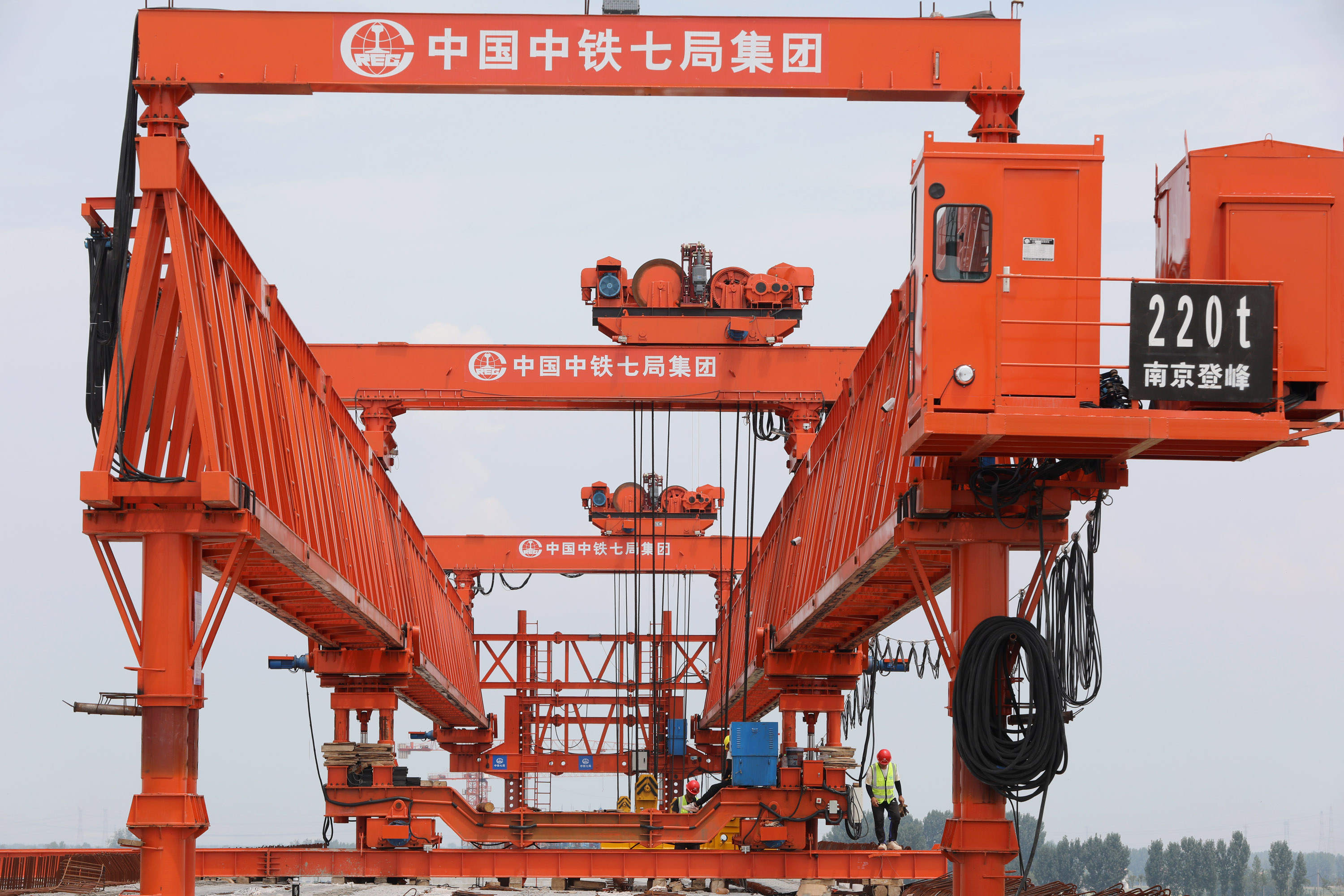 8月3日，建设者们在G207河南焦作至温县快速通道项目沁河特大桥工地架设桥梁。